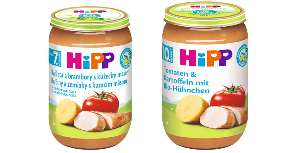 Two glass jars with labels, one with a tomato and the other with a tomato and potato, are displayed.